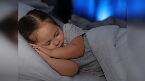 Child sleeping peacefully in a cozy bed
