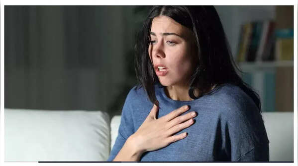 Image of a person holding their stomach in discomfort